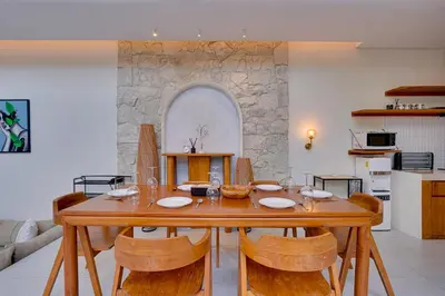 a dining room with a wooden table and chairs at Private 3BR Villa Sweetie with Pool Seminyak in Seminyak