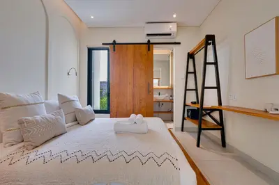 a bedroom with a large bed and a ladder at Private 3BR Villa Sweetie with Pool Seminyak in Seminyak