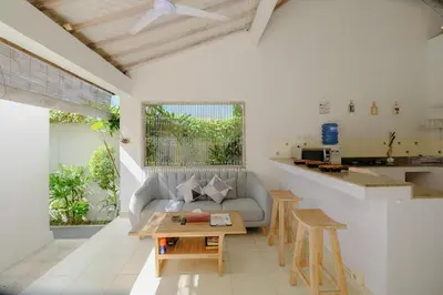 a living room with a couch and a table at Villa Beji Ayu Seminyak - 2 Bedroom Private Pool in Seminyak