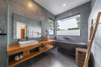 a bathroom with a tub and a sink and a mirror at Lindt - 3BR Villa with Private Pool and Ricefield View in Canggu