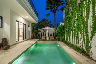 a swimming pool in the backyard of a house at Lindt - 3BR Villa with Private Pool and Ricefield View in Canggu