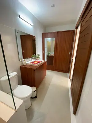 a bathroom with a toilet and a sink and a mirror at Arts Ebena Villa Two-Bedroom Private Pool Kuta in Seminyak