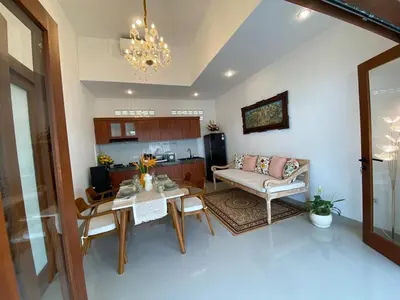 a living room with a table and a couch at Arts Ebena Villa Two-Bedroom Private Pool Kuta in Seminyak