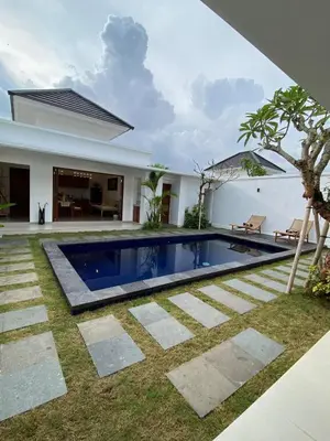 a swimming pool in the backyard of a house at Arts Ebena Villa Two-Bedroom Private Pool Kuta in Seminyak