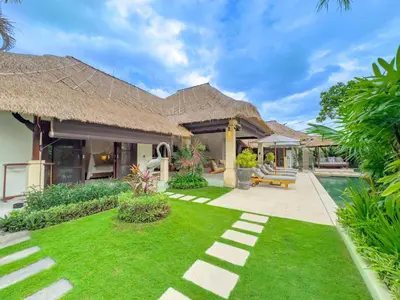 a villa with a yard and a swimming pool at Villas Seminyak in Seminyak