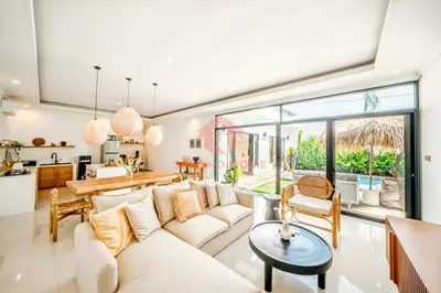 a living room with a white couch and a table at Luxury 3BR Umalas Villa Pool & Wi-Fi in Kerobokan