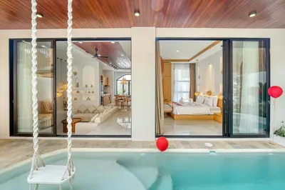 a swimming pool with a swing in a house at Villa Tébu 3 BR Brand New Villa in Umalas in Kerobokan