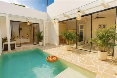 a swimming pool in a house with plants at 5 min to Finns Beach Club & Trendy Hotspot in Canggu