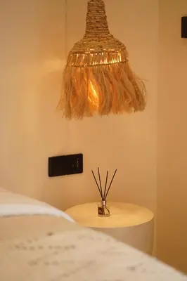 a light hanging over a table next to a bed at 5 min to Finns Beach Club & Trendy Hotspot in Canggu