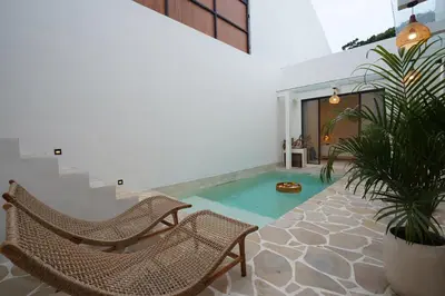 a pool in a house with chairs and plants at 5 min to Finns Beach Club & Trendy Hotspot in Canggu