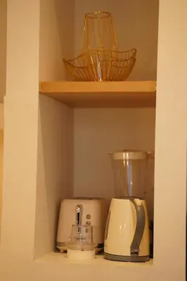a shelf with two kitchen appliances on it at 5 min to Finns Beach Club & Trendy Hotspot in Canggu