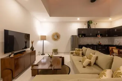 a living room with a couch and a tv at Villa Sunshyne in Seminyak