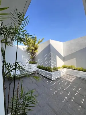 a courtyard with trees and plants in a building at Villa Jasmine in Seminyak