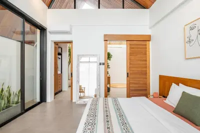 a bedroom with a bed and a sliding glass door at 2BR Villa in Canggu, Villa Sejiwa 3 in Canggu