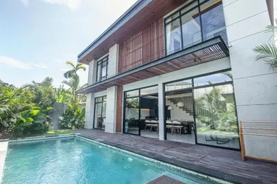 an external view of a house with a swimming pool at Hidden Paradise 5BR Canggu Gem Near Waves in Canggu