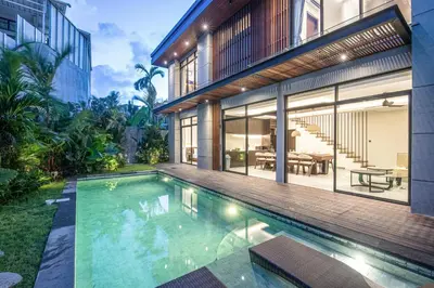 an external view of a house with a swimming pool at Hidden Paradise 5BR Canggu Gem Near Waves in Canggu