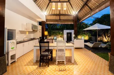 a kitchen and dining room with a table and chairs at Karen's Tropical Villa in Seminyak