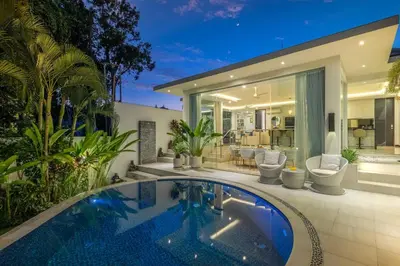 a house with a swimming pool in front of a house at Villa Mattina, Umalas in Canggu