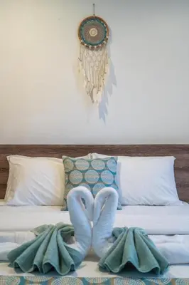 a bed with two mitts in the shape of a heart at Villa Azure 2 - Private Pool Villa near Seminyak Centre in Seminyak