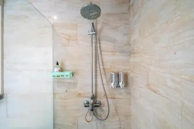 a shower with a shower head in a bathroom at Villa Azure 2 - Private Pool Villa near Seminyak Centre in Seminyak