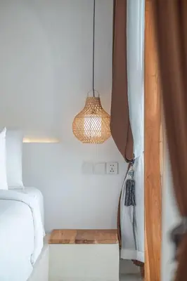 a bedroom with a bed and a pendant light at Villa MAVI Seminyak in Seminyak