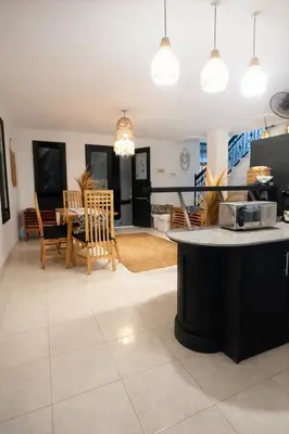 a kitchen and living room with a table and chairs at 3 Bedroom Villa in Prime Seminyak Location, Walk to Beach in Seminyak