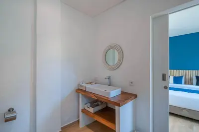 a bathroom with a sink and a mirror at Wave - 6BR Luxe Canggu Villa with Rooftop & Pool in Canggu
