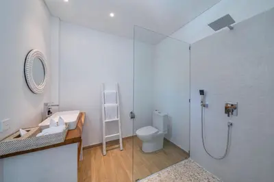 a bathroom with a shower and a toilet at Wave - 6BR Luxe Canggu Villa with Rooftop & Pool in Canggu