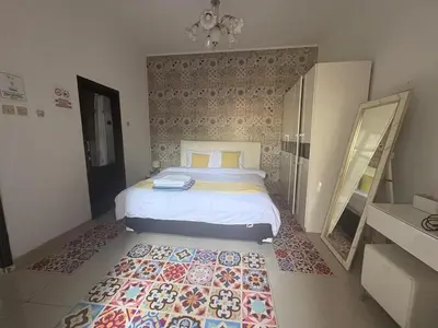 a bedroom with a bed and a rug on the floor at Villa Rumah Lemon Nusa Dua in Nusa Dua