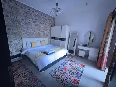a bedroom with a large bed and a mirror at Villa Rumah Lemon Nusa Dua in Nusa Dua