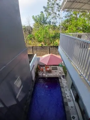 a view from the balcony of a house with blue water at Villa Rumah Lemon Nusa Dua in Nusa Dua