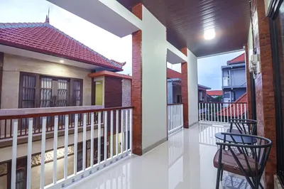 a balcony of a house with two chairs at The Hunian in Seminyak