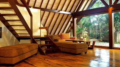 a living room with a couch and a table at Kalyca Seminyak 4 Bedroom in Seminyak