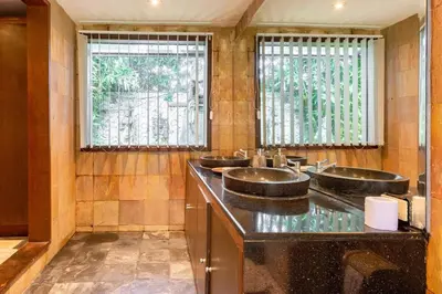 a bathroom with three sinks and two windows at Kalyca Seminyak 4 Bedroom in Seminyak