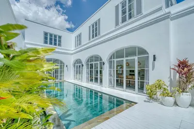 an exterior view of a house with a swimming pool at Colonial Style 3BR Walking Distance to the Beach in Canggu