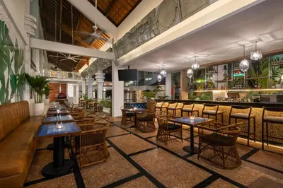 a restaurant with tables and chairs and a bar at Montigo Resorts Seminyak in Seminyak