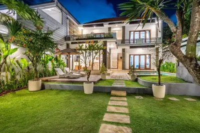 an exterior view of a house with a garden at Villa Avaluna by JB Villas in Seminyak
