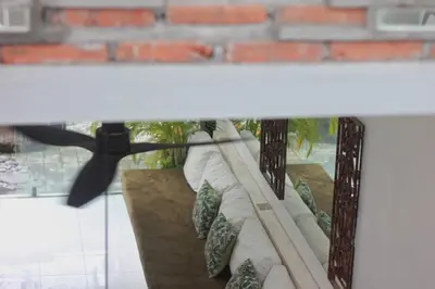 a bed with pillows on it with a helicopter at Villa Marabia - Charming Quiet 3BR in Seminyak in Seminyak