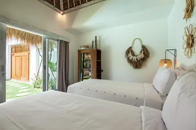 two white beds in a bedroom with a window at New 5 bedroom Villa close to Seminyak eat street in Seminyak