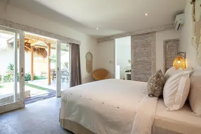 a bedroom with a large bed and a large window at New 5 bedroom Villa close to Seminyak eat street in Seminyak