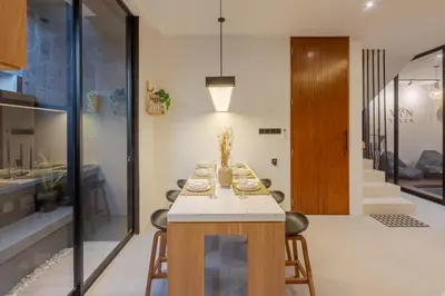 a dining room with a table and some chairs at Vin Villa Kerobokan 2BR with Private Pool in Kerobokan