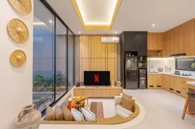 a living room with a tv and a kitchen at Vin Villa Kerobokan 2BR with Private Pool in Kerobokan
