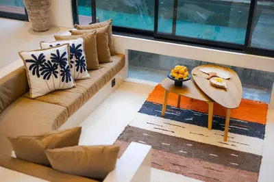 a living room with a couch and a table at Vin Villa Kerobokan 2BR with Private Pool in Kerobokan