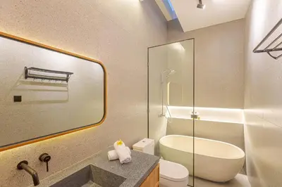 a bathroom with a sink and a toilet and a shower at Vin Villa Kerobokan 2BR with Private Pool in Kerobokan