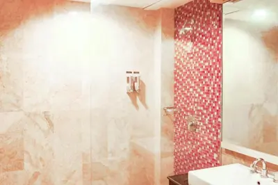 a bathroom with a shower and a sink at First Home Stay in Ngurah Rai International Airport