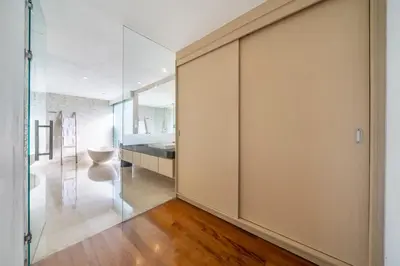a pivot door in a room with a bedroom at Villa Aquila in Seminyak