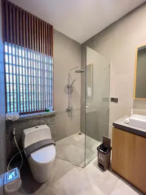 a bathroom with a toilet and a shower and a sink at Villa in South Kuta Dewi Amerta villa in Jimbaran