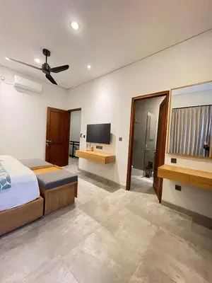 a bedroom with a bed and a flat screen tv at Villa in South Kuta Dewi Amerta villa in Jimbaran