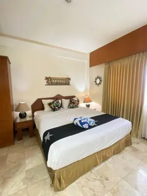 a bedroom with a large bed in a room at The Coastal Apartment at Jayakarta Residence in Seminyak