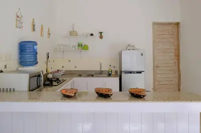 a kitchen with three baskets on a counter with a refrigerator at Beji Ayu Seminyak - 1 Bedroom Private Villa in Seminyak